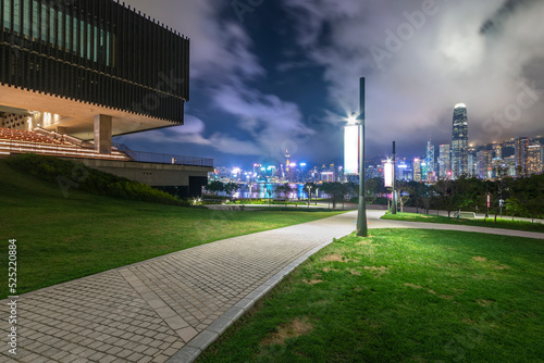 Photography pedestrian walkway in park and skyline of Hong Kong city at night