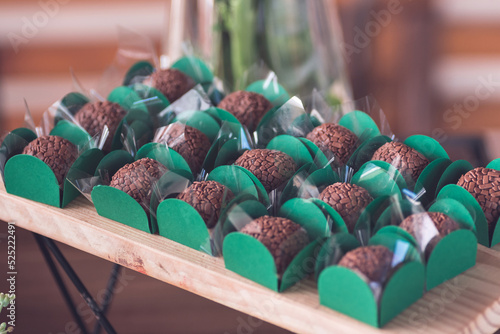 a wooden tray with party brigadiers in green molds photo