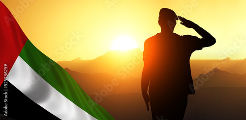 Silhouette Of A Solider Saluting Against the flag of UAE. Concept of national muslim holidays. Independence Day, Victory Day.