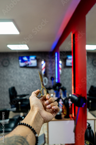 Man in a barbershop. Person cutting his hair and beard.