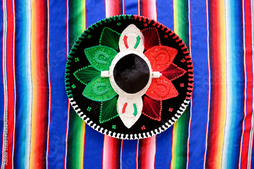 Mexican charro hat on serape. Typical mexican hat with the colors of the mexican flag. photo