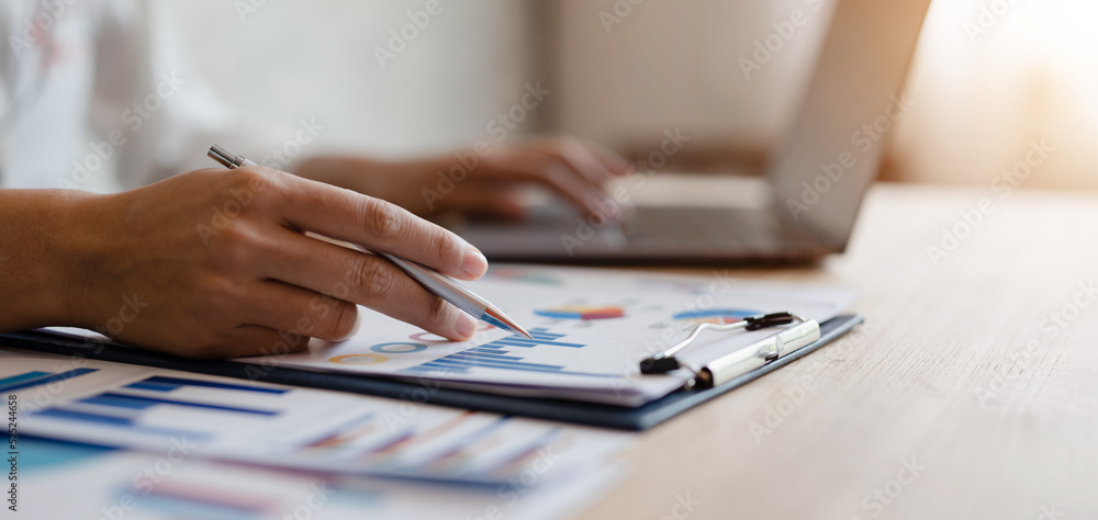 business man analyzing work on desk with job graphics and The laptop is a tool for analyzing tasks. business man analyzing work on desk with job graphics and The laptop is a tool for analyzing tasks.