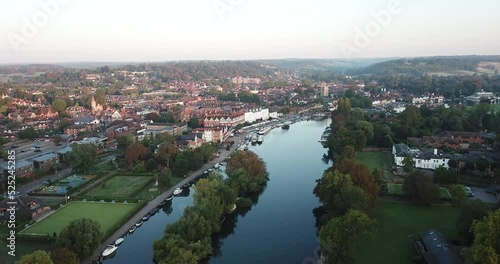 Beautiful morning drone shot of Henley on Thames, panning high above the river and moving towards the town from the West. photo