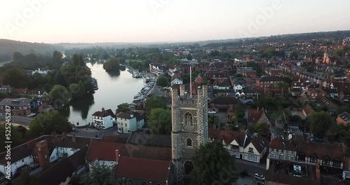 Spectacular drone shot of Henley on Thames at sunrise. The clip circles around the church showing a panorama of the whole area. photo