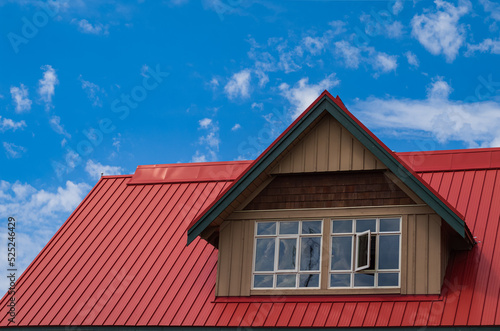 Wallpaper Mural Red roof with dormer in the blue sky background. Decorative metal roof. Types of roof roofs. Roofing Torontodigital.ca