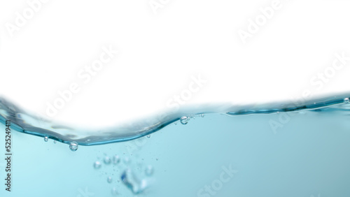 Water waves splashing with air bubbles isolated on a white background. Abstract blue water wave on white background. For product, advertisement, text space.