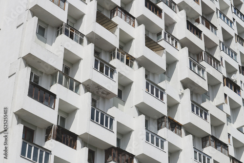 Windows and balconies of a multi-storey residential building.
