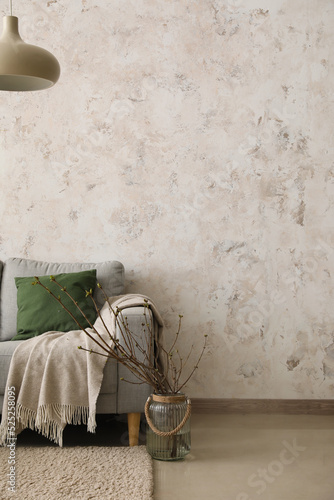 Sofa and vase with branches...