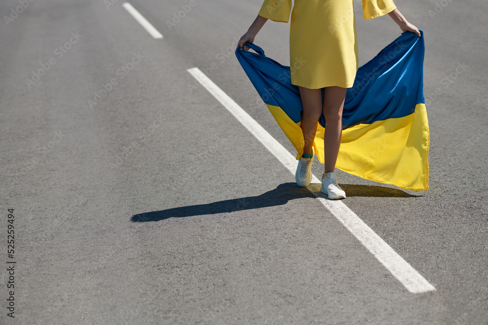 Φωτογραφία woman with the Ukrainian flag, a girl with ukrainian flag on the road, a girl wi