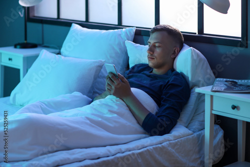 Young man using mobile phon...