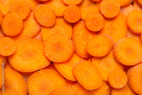 Slices of fresh carrots as background, closeup