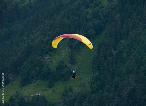 A picture with motion blur and noise effect of paragliding at Lauterbrunnen Valley
