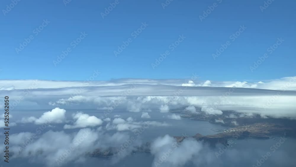Aerial view from a jet cockpit of Madeira Island during the approach at 1000m high to Funchal airport in cloudy summer day. 4K 60FPS. Aerial view from a jet cockpit of Madeira Island during the approach at 1000m high to Funchal airport in cloudy summer day. 4K 60FPS.
