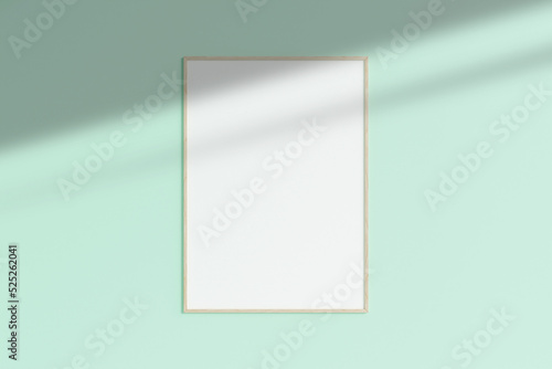 Realistic wooden vertical photo frame mockup hanging on empty wall room with shadow. 3d rendering.