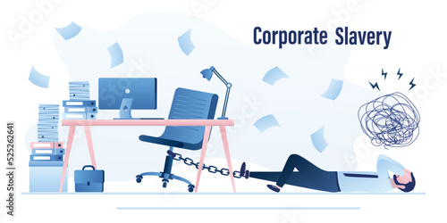 Corporate slavery, concept. Unhappy manager is chained to workplace, overwork. Burnout at work. Businessman lying on floor in office. Psychological pressure, stress. Dissatisfaction with job.