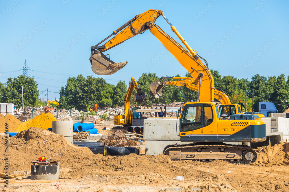 Work of excavating machine on building construction site