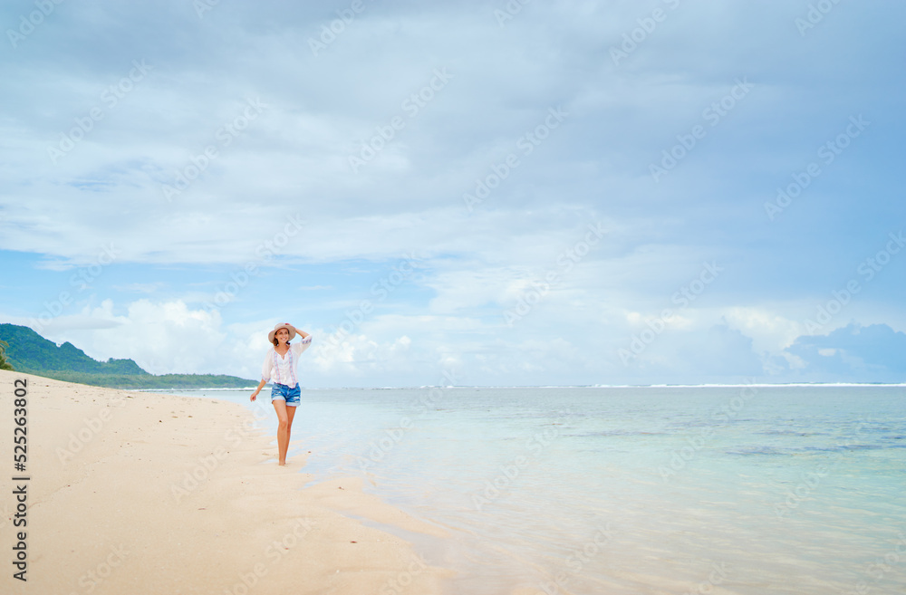 Vacation on the seashore. Young woman walking on the beautiful tropical white sand beach. Vacation on the seashore. Young woman walking on the beautiful tropical white sand beach.