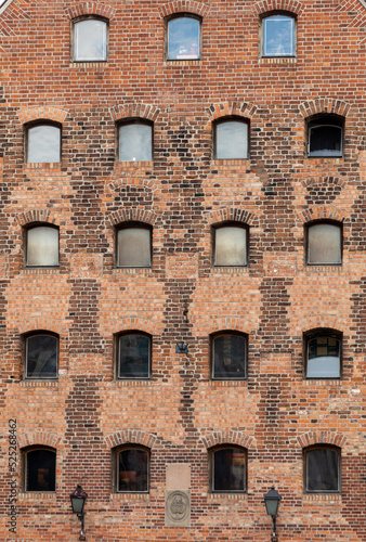 Facade of restored medieval granary on the Granary island in the old town of Gdansk . Poland