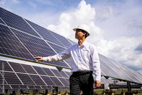 Businessman on a tour of solar power plants to check the operation of the power generation system. solar panels are an alternative electricity source to be sustainable resources in the future