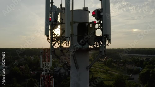 Aerial drone view of cellular antenna tower 5g 4g at sunset, GSM. Introduction, improvement, distribution of base stations.