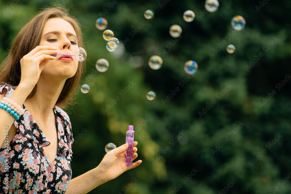 Woman blowing soap bubbles, having fun Woman blowing soap bubbles, having fun