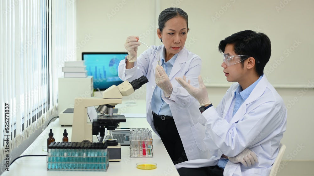 Team of professional scientists talking, working together in laboratory for biotechnology development Team of professional scientists talking, working together in laboratory for biotechnology development