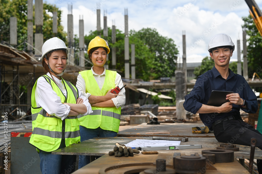 Civil engineer manager and architects in hardhats and reflective jackets inspecting commercial building construction site Civil engineer manager and architects in hardhats and reflective jackets inspecting commercial building construction site