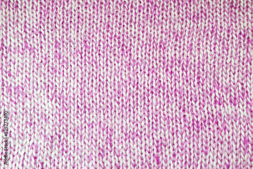 Close up background of knitted wool fabric with dots pattern. Bright purple color crumpled knitting wool knitwear texture. Openwork abstract knitted jersey fabric abstract backdrop