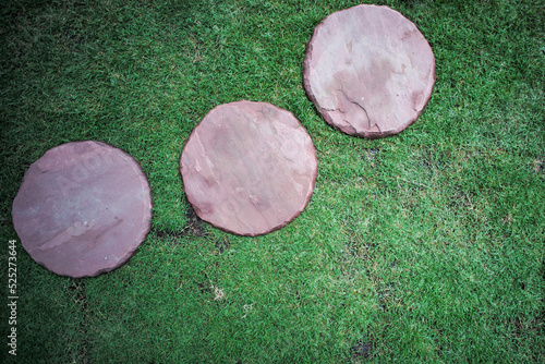 Top view group of sand stone in round shape place on the grass field for walking at the outdoor garden