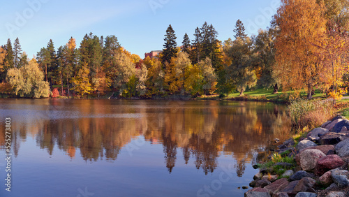 Northern European landscape in Finnish Kellokoski: golden autumn, rapids, Kerava river, sunny day, church near.