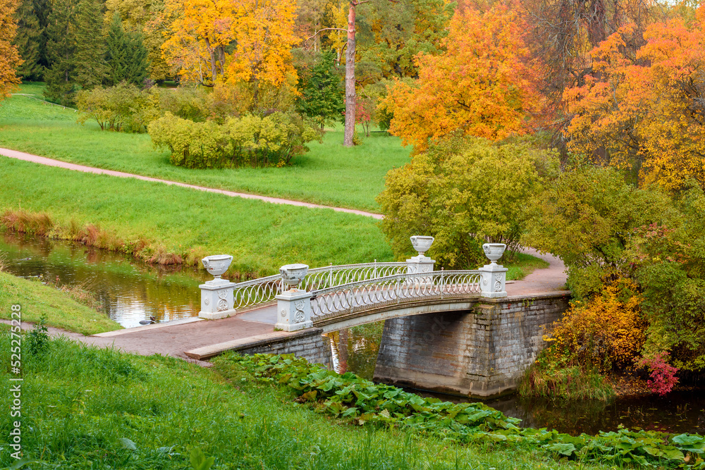 Bridge in autumn foliage in Pavlovsky park, Pavlovsk, Saint Petersburg, Russia Bridge in autumn foliage in Pavlovsky park, Pavlovsk, Saint Petersburg, Russia