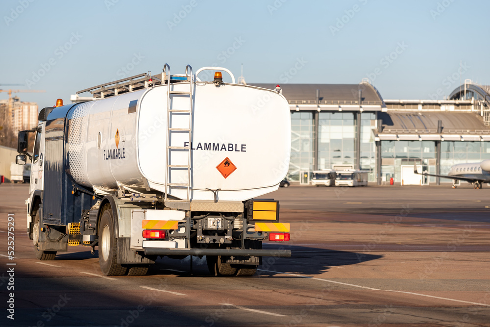 Foto Stock Back view small modern fuel tanker truck driving on airfield