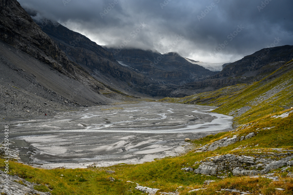 Lämmerenboden with meandering creek and wildstrubel glacier in the distance in valais