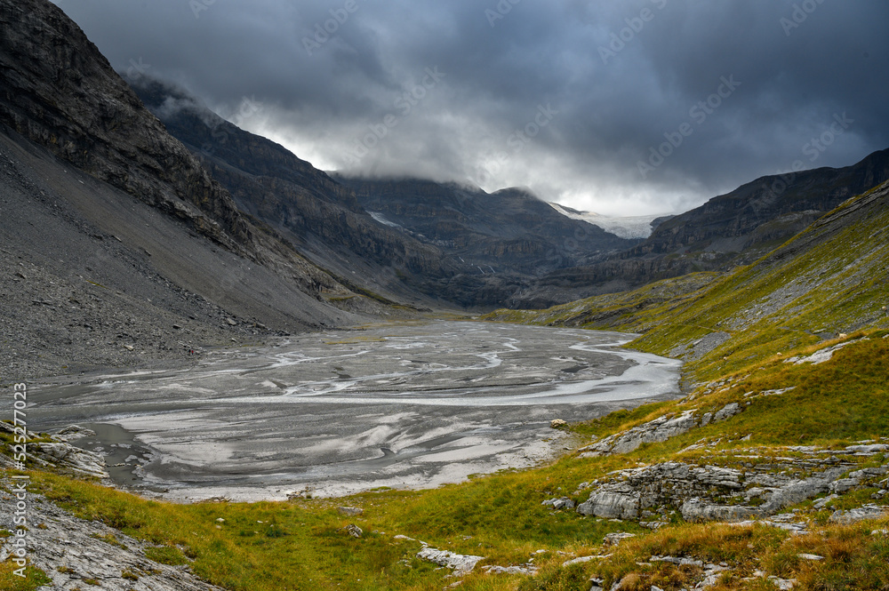 Lämmerenboden with meandering creek and wildstrubel glacier in the distance in valais