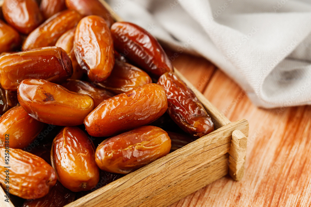 juicy royal dates on a wooden rustic background juicy royal dates on a wooden rustic background