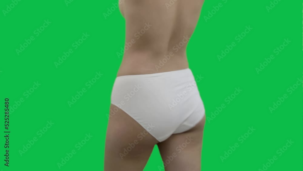 A sexy hip-hop female dance artist in white panties, dancing against green background. Isolated. A sexy hip-hop female dance artist in white panties, dancing against green background. Isolated.