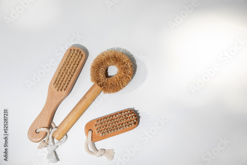 Eco brushes with wooden handles on a white background with shadows. Top view