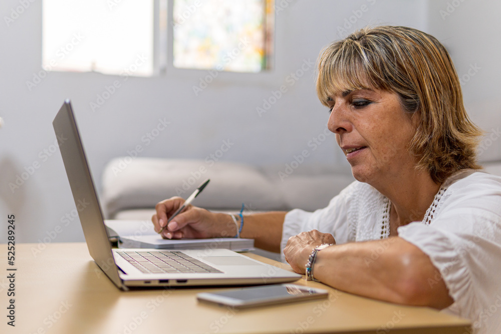 Adult woman at work, taking notes in her diary. Adult woman at work, taking notes in her diary.