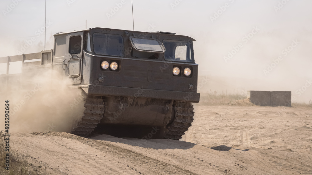 TRACKED ARTILLERY TRACTOR - Military vehicle on a dirt road TRACKED ARTILLERY TRACTOR - Military vehicle on a dirt road