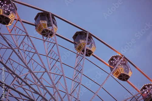 Ferris wheel on a warm summer evening.Shot against blue sky.