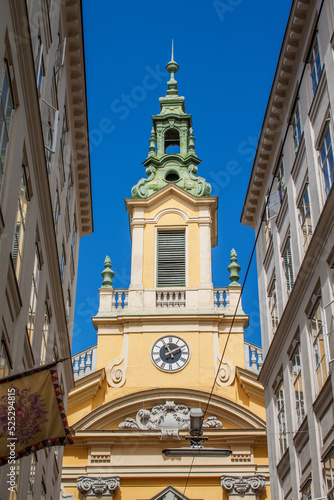 Exterior view of the historical Dorotheerkirche Stadtkirche Church. Ancient tower among old town buildings in downtown Vienna, Austria, Central Europe. Viennese downtown neighborhood houses. 