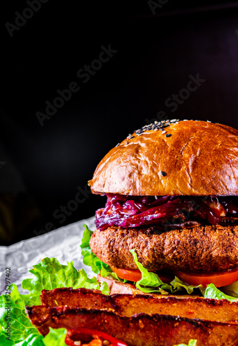 chicken burger with vegetables on dark background