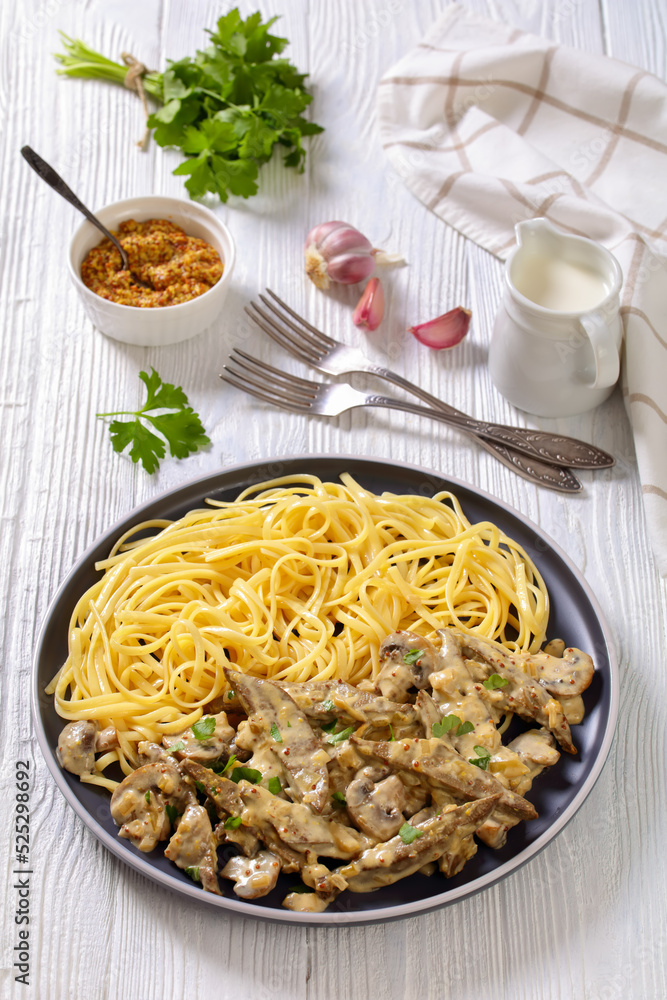 liver stroganoff with spaghetti on plate, top view
