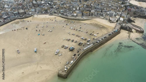 View From Above Of St Ives Lighthouse On Smeatons Pier Near St Ives Harbour In Cornwall, UK. aerial photo
