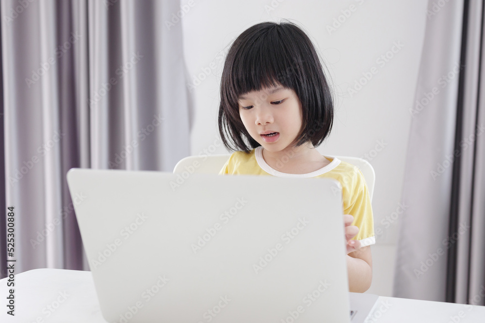 little asian girl student study online using laptop computer at home little asian girl student study online using laptop computer at home