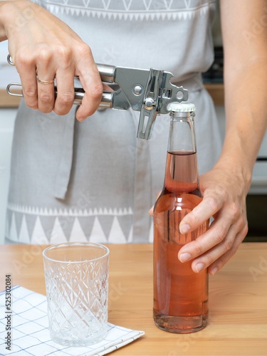 opener open a glass bottle and pour into a glass