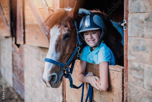 Beautiful girl enjoying with her horse outdoors at ranch.