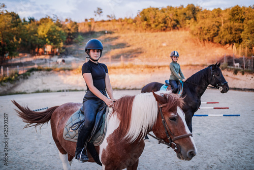Two beautiful girls riding their horses outdoors at ranch. © hedgehog94