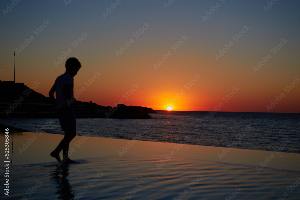 silhouette of a person on the beach sunset