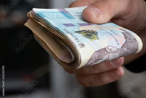 Money of Ukraine. Stack of ukrainian hryvnia banknotes in hands. Hryvnia 1000 uah